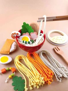 an assortment of crafting supplies laid out in a bowl on top of a table