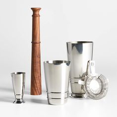 three silver cups and one wooden stick