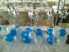 blue and white balloons are arranged on the table for a party at a wedding reception