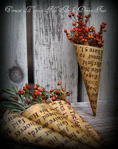 a vase filled with flowers sitting on top of a table next to a wooden fence