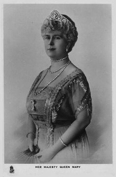 an old black and white photo of a woman wearing a tiara