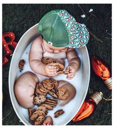 a baby sitting in a bath filled with cookies