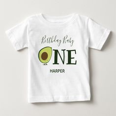 An avocado t-shirt for your baby’s first birthday. The baby shirt has a color scheme of green and white with the word "One" in large letters and a cute, smiling, avocado cartoon as the first letter of the word. Simply customize this shirt, add it to your cart, and happy birthday to your wonderful baby!

Avocado One 1st First Birthday Baby T-Shirt
Sweetsham Food Art | ©Melissa Patton - Artist/Illustrator Customizable Green T-shirt For Birthday, Funny First Birthday T-shirt, Green Fun Birthday T-shirt, First Birthday Graphic Tee With Name Print, Fun Green T-shirt For Birthday, Graphic Tee With Name Print For First Birthday, Green Cotton T-shirt For First Birthday, Green Graphic Print T-shirt For First Birthday, Cute Green Tops With Name Print