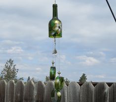 a wind chime hanging from a wooden fence