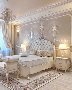 an elegant bedroom with white furniture and chandelier