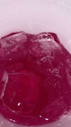 a pitcher filled with ice and water on top of a table