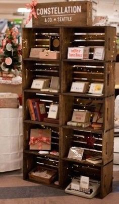 there is a book shelf that has many books on it and christmas decorations in the background