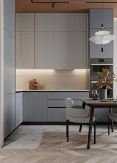 a modern kitchen with grey cabinets and wood flooring is seen in this image from the dining room