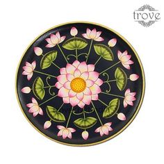 a black plate with pink flowers on it