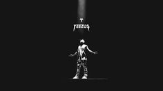 a black and white photo of a man standing in front of a cross with the word yeezus on it