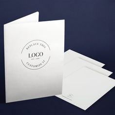 two white envelopes with the company logo printed on them, next to each other