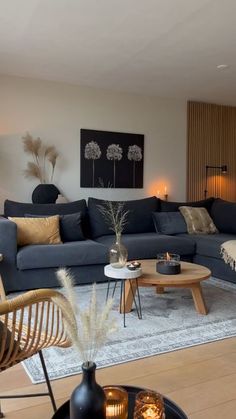 a living room filled with lots of furniture next to a wall mounted painting on the wall