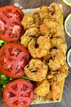 fried shrimp with tomatoes and lettuce on toasted bread