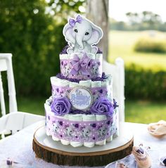 a purple and white cake with an elephant on top