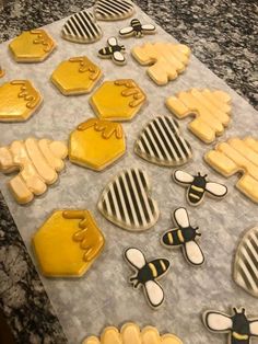 decorated cookies with honeybees and bees on top of a marble countertop in the kitchen