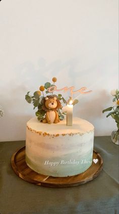 a birthday cake with a teddy bear on top