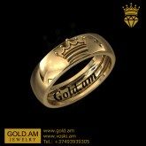 a gold ring with the word golden on it and a crown in the middle, against a black background