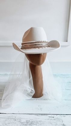 a white hat with veil and beads on it