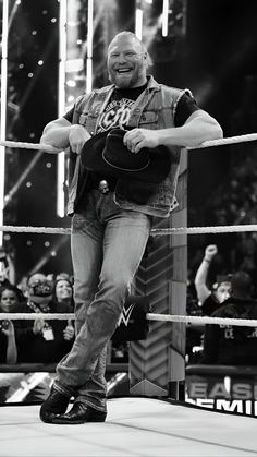 a man standing on top of a wrestling ring