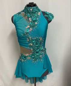 a blue dress with sequins and flowers on it