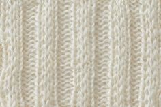 the texture of a white knitted fabric is shown in close - up, as well as horizontal stripes