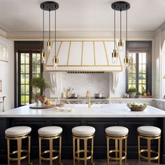 a kitchen with white counter tops and gold bar stools in front of an island