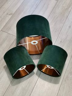 three green velvet lamps on wooden flooring