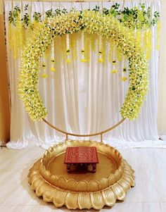 a table topped with a gold plate covered in flowers