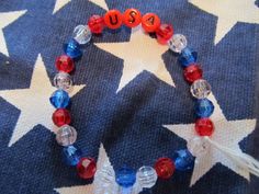 This is a USA Beaded Bracelet.  It has red USA letter beads. It has red, white, and blue 6mm faceted beads. It was made with .8mm sturdy stretch string. I tie it several times to prevent breakage. It fits girls ages 5-9. It stretches to fit on the wrist. It would make a great addition to a girls Fourth of July outfit. It would make a cute gift for a Birthday. All items are ready to be shipped I do combined shipping. Items ship in 2-5 business days. Check out more items at: http://www.etsy.com/sh Patriotic Bracelet, Bracelets For Girls, Easter Bunny Girl, Kids Bracelets, Christmas Bracelet, Gold Bracelet For Women, White Gold Bracelet, Stocking Stuffer Gifts, Letter Beads