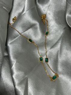 * Material - Gold Plated on Stainless Steel with an Emerald look stones * Necklace length - 47cm chain / 0.6cm*0.4cm pendants * Non-tarnish material * Perfect for people with sensitive skin, hypoallergenic  PACKAGING  * All our jewellery pieces will come packaged in an airtight plastic pouch, this is to ensure your product will not be damaged during transit * Items will be posted to you in a protective padded envelope  * All orders will also come with a 'care card' on how to best care for your j Gold Emerald Necklace With Adjustable Chain For Formal Events, Gold Emerald Necklace With Adjustable Chain For Formal Occasions, Emerald Necklace With Delicate Chain For Gift, Emerald Necklace With Delicate Chain As Gift, Green Metal Clavicle Chain Necklace, Formal Green Necklace With Delicate Chain, Elegant Green Clavicle Chain Necklace, Elegant May Birthstone Necklace With Delicate Chain, Elegant Metal Necklace With Square Pendant