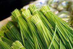 bundles of green grass sitting on top of a table