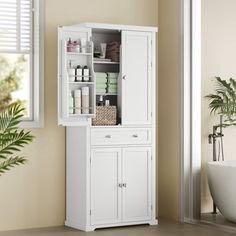 a white cabinet in a bathroom next to a bath tub