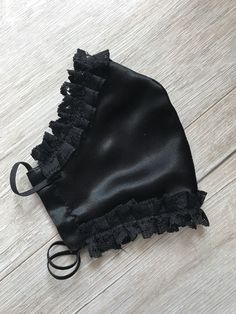 a black face mask with ruffles on it