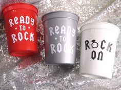 three plastic cups with the words ready to rock written on them sitting next to each other