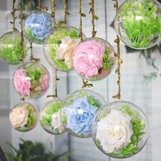 there are many different colored flowers in glass balls hanging from the ceiling ornament