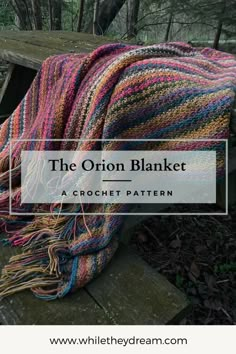 a colorful blanket sitting on top of a wooden bench in the woods with text overlay that reads, the onion blanket