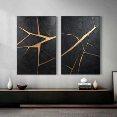 two black and gold paintings in a living room