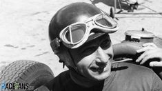 a black and white photo of a man wearing a helmet with goggles on his head