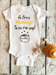 a baby bodysuit that says, a little hungo is on the way with honey next to it