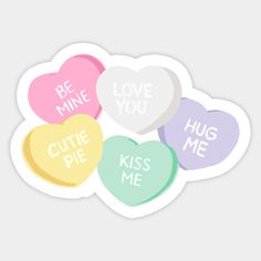 six conversation hearts with the words be mine, love you, hug me and kiss me