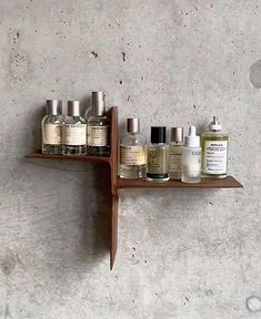 a shelf that has some bottles on it and one is hanging from the wall above