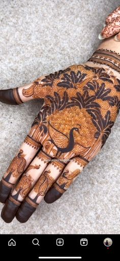 a person's hand with henna tattoos on it