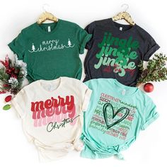 three t - shirts that say merry christmas and one has a heart on the front