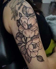 a woman's arm with flowers on it