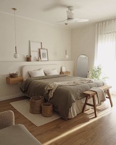 a bedroom with a large bed and wooden floors