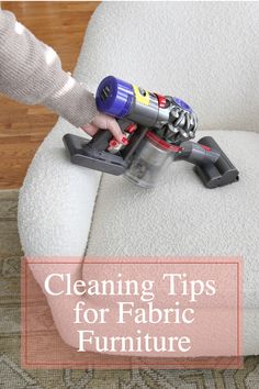 a person using a vacuum to clean a chair with the words cleaning tips for fabric furniture