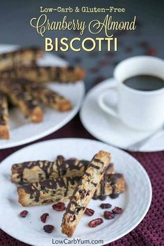 cranberry almond biscotti on a plate next to a cup of coffee