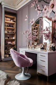 a dressing table with a mirror, stool and flowers on the wall next to it