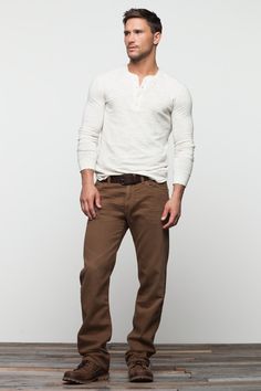 A white henley shirt is a staple for any guys wardrobe. Brown Chinos, Man Standing, Cooler Look, Brown Pants, Men Looks, Henley Shirts, Street Styles