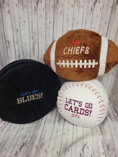 three different sports balls sitting next to each other on a white wooden surface with the words chiefs and let's go cards written on them